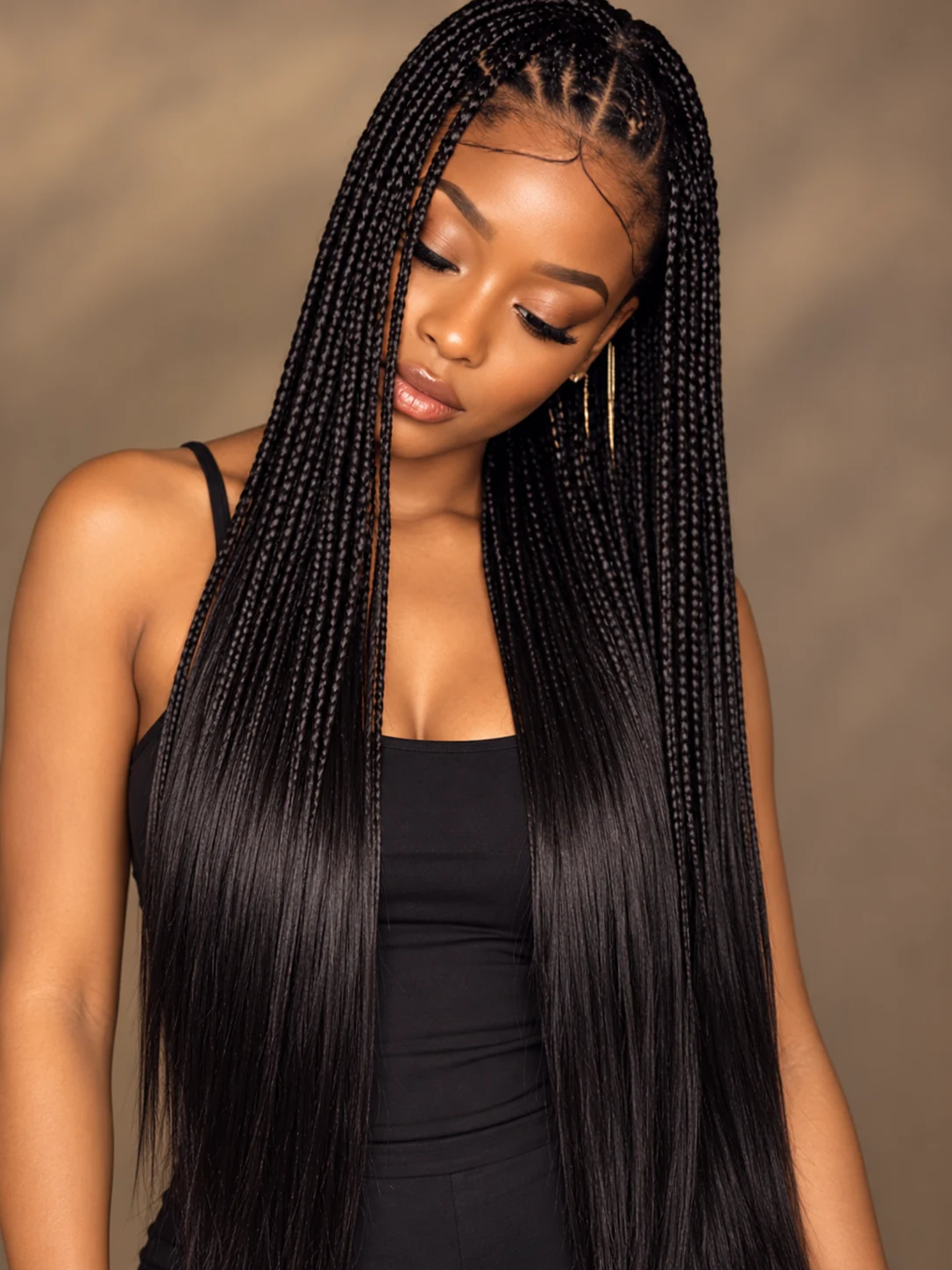 Bone Straight extensions braided into the model’s hair in 1B Natural Black